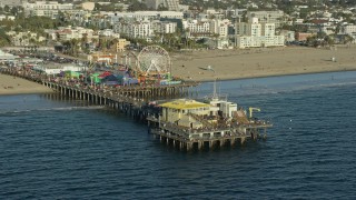 AX0161_080E - 7.6K aerial stock footage of tourists at Santa Monica Pier in Santa Monica, California