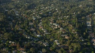 AX0161_087 - 7.6K aerial stock footage passing upscale, tree-lined neighborhoods in Brentwood, California