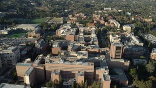 AX0161_093 - 7.6K stock footage aerial video orbiting College university campus buildings in Los Angeles, California