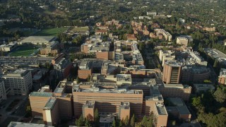 AX0161_093E - 7.6K aerial stock footage orbiting College university campus buildings in Los Angeles, California