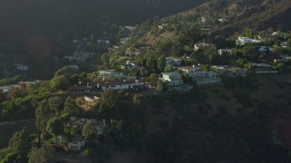 AX0161_100 - 7.6K aerial stock footage of hilltop mansions in Beverly Hills, California