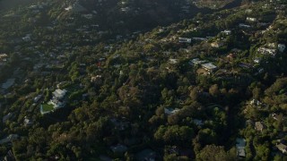 AX0161_103 - 7.6K aerial stock footage flying away from hillside mansions in Beverly Hills, California
