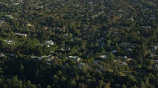 AX0161_104 - 7.6K aerial stock footage flying by mansions in upscale neighborhoods in Beverly Hills, California