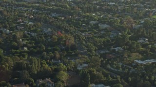 AX0161_105 - 7.6K aerial stock footage flying by mansions in upscale neighborhoods in Beverly Hills, California