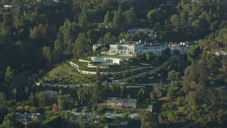 AX0161_107 - 7.6K aerial stock footage flying by a large hillside mansion in Beverly Hills, California