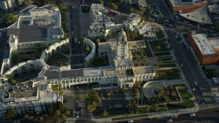 AX0161_118 - 7.6K aerial stock footage flying by and away from city hall in Beverly Hills, California