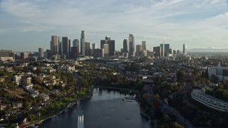 AX0162_001E - 7.6K aerial stock footage flying over Echo Park Lake to approach the skyline in Downtown Los Angeles, California