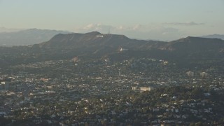 AX0162_043E - 7.6K aerial stock footage of the Hollywood Sign and Griffith Observatory seen from Silver Lake, California