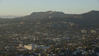 AX0162_046E - 7.6K aerial stock footage flying over Los Felix to approach Hollywood Sign and Griffith Observatory in Los Angeles, California