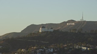 AX0162_051E - 7.6K aerial stock footage orbiting Griffith Observatory to reveal the Hollywood Sign in Los Angeles, California