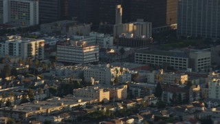 AX0162_057E - 7.6K aerial stock footage of an LAPD helicopter flying over Hollywood and Koreatown, California