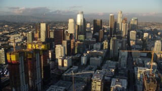 AX0162_069 - 7.6K stock footage aerial video of skyscrapers seen from Oceanwide Plaza at sunset in Downtown Los Angeles, California