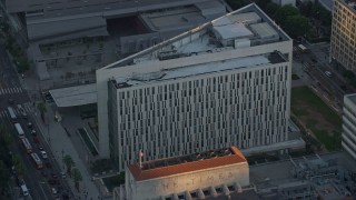 AX0162_073 - 7.6K aerial stock footage approaching the LAPD headquarters at twilight in Downtown Los Angeles, California