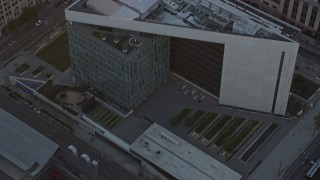 AX0162_074 - 7.6K aerial stock footage orbiting the LAPD headquarters at twilight in Downtown Los Angeles, California