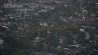 AX0162_091 - 7.6K aerial stock footage tracking an LAPD helicopter flying over Silver Lake, twilight, Los Angeles, California