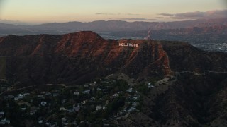 AX0162_100 - 7.6K aerial stock footage of the Hollywood Sign in Los Angeles, California at twilight