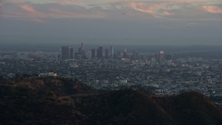 AX0162_105 - 7.6K aerial stock footage of Downtown Los Angeles, California at twilight, reveal Griffith Observatory