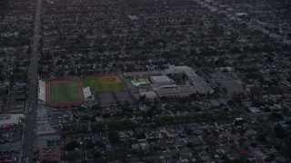 AX0162_111E - 7.6K aerial stock footage of John Burroughs High School at twilight in Burbank, California