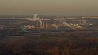 AX0163_0001 - 4K aerial stock footage of flying by an oil refinery at sunset in Romeoville, Illinois