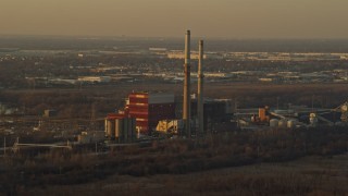 AX0163_0002 - 4K aerial stock footage of flying by a coal-fired power plant at sunset in Romeoville, Illinois