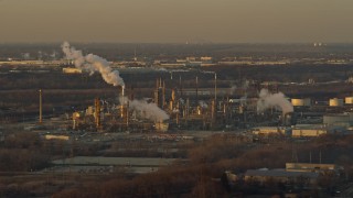 AX0163_0003 - 4K aerial stock footage of passing by an oil refinery at sunset in Romeoville, Illinois