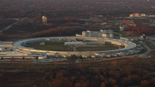 AX0163_0007 - 4K aerial stock footage of the Advanced Photon Source at the Argonne National Laboratory at sunset in Lemont, Illinois