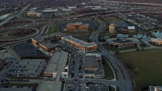 AX0163_0011 - 4K aerial stock footage of approaching and flying past a shopping mall at sunset in Burr Ridge, Illinois