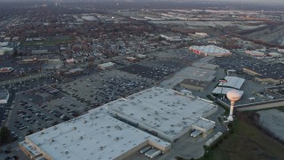 AX0163_0014 - 4K aerial stock footage fly over a shopping mall and parking lot at sunset in Hodgkins, Illinois
