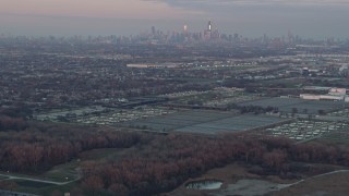AX0163_0017 - 4K aerial stock footage tilt from homes to reveal Chicago skyline at sunset in Forest View, Illinois