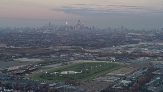 AX0163_0018 - 4K aerial stock footage of approaching the Chicago skyline at sunset from a racetrack in Stickney, Illinois