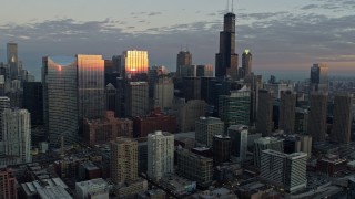 AX0163_0029 - 4K aerial stock footage of approaching  skyscrapers reflecting the sunset, Downtown Chicago, Illinois