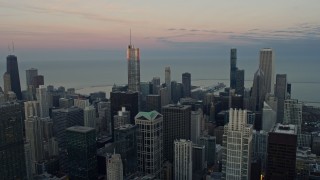 AX0163_0031 - 4K aerial stock footage of Trump Tower reflecting the sunset and downtown high-rises, Downtown Chicago, Illinois