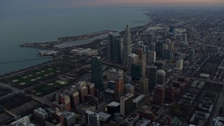 AX0163_0042 - 4K aerial stock footage of Grant Park and the Field Museum at twilight, Downtown Chicago, Illinois