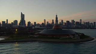 AX0163_0045 - 4K aerial stock footage flyby Shedd Aquarium, reveal Adler Planetarium, city skyline at twilight, Downtown Chicago, Illinois