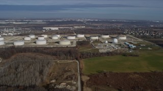 AX0165_0002 - 4K aerial stock footage of flying by giant storage tanks in Lemont, Illinois