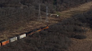 AX0165_0004 - 4K aerial stock footage of a train cruising past the countryside  in Lemont, Illinois