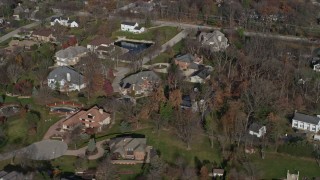 AX0165_0007 - 4K aerial stock footage of flying by large, upscale homes in Burr Ridge, Illinois