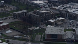 AX0165_0022 - 4K aerial stock footage of a reverse view of buildings at the Cook County Jail complex in West Side Chicago, Illinois skyline