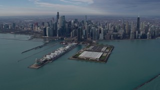 AX0165_0034 - 4K aerial stock footage of flying by tall, waterfront skyscrapers and Navy Pier in Downtown Chicago, Illinois