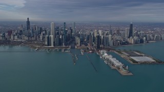AX0165_0035 - 4K aerial stock footage of passing by tall, waterfront skyscrapers and Navy Pier in Downtown Chicago, Illinois