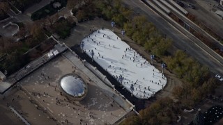 AX0165_0040 - 4K stock footage aerial video of the Cloud Gate sculpture and ice skating rink at Grant Park, Downtown Chicago, Illinois