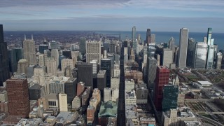 AX0165_0051 - 4K aerial stock footage of following State Street among Downtown Chicago skyscrapers, Illinois