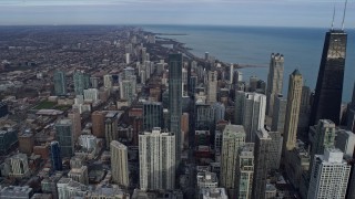 AX0165_0053 - 4K aerial stock footage of following State Street past Downtown Chicago skyscrapers, Illinois