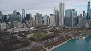 AX0165_0064 - 4K aerial stock footage of flying over Grant Park to approach Downtown Chicago skyscrapers, Illinois