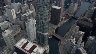 AX0165_0065 - 4K aerial stock footage tilt from skyscrapers to reveal Chicago River in Downtown Chicago, Illinois