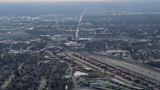 AX0166_0018 - 4K aerial stock footage of tracking a commercial jet descending for a landing, Northwest  Side Chicago, Illinois