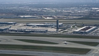 AX0166_0021 - 4K aerial stock footage of the control tower and terminals at O'Hare International Airport, Chicago, Illinois