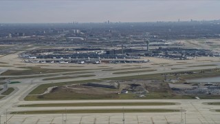 AX0166_0022 - 4K aerial stock footage of a reverse view of control tower and terminals at O'Hare International Airport, Chicago, Illinois