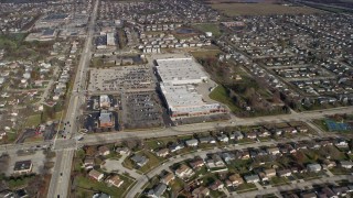 AX0166_0026 - 4K aerial stock footage of flying over a quiet suburban neighborhood, tilt to shopping mall in Elk Grove Village, Illinois