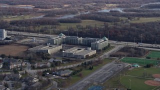 AX0166_0027 - 4K aerial stock footage of baseball and soccer fields near office buildings in Schaumburg, Illinois